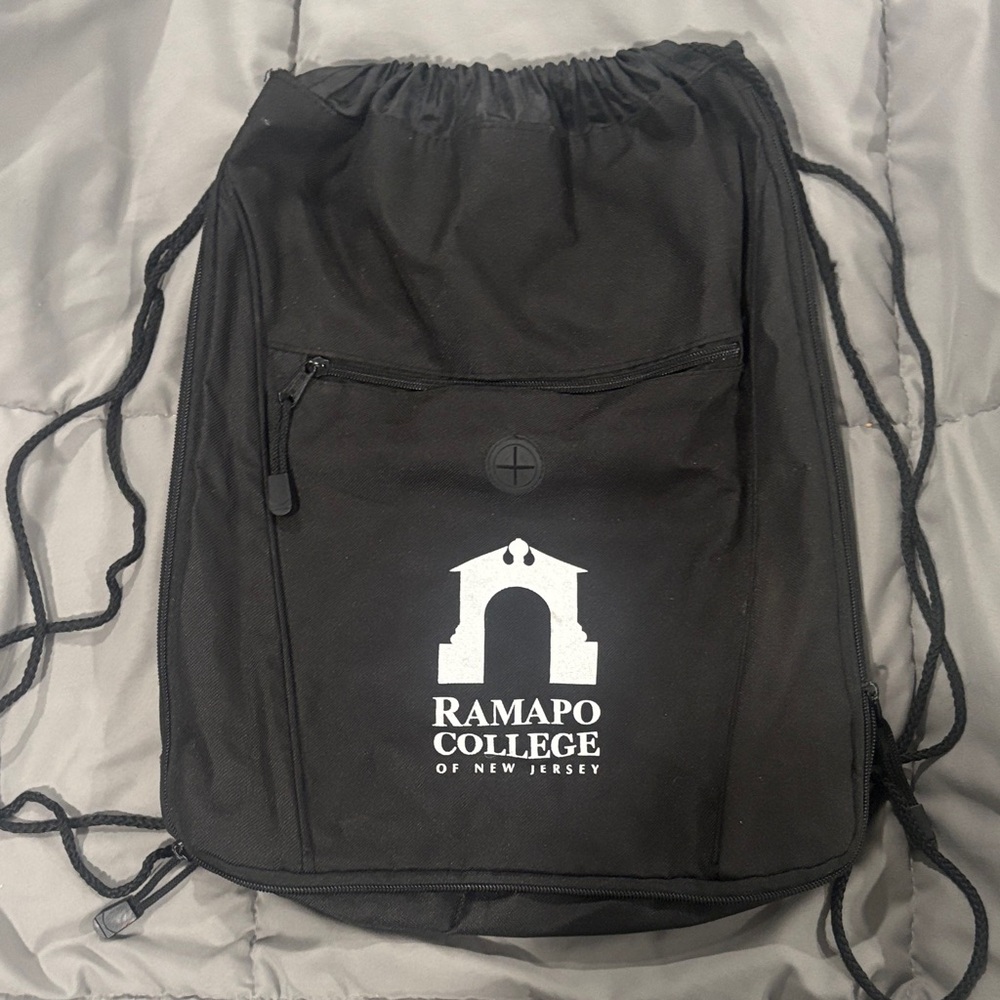 Ramapo College black sling bag backpack with front zipper pocket